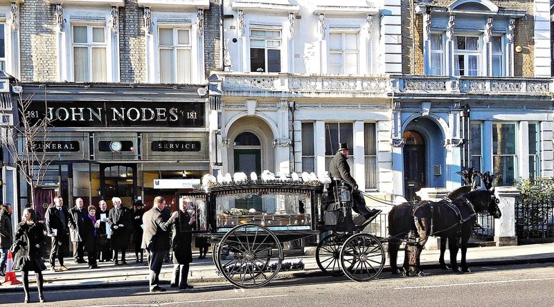Horse-drawn hearse outside John Nodes Funeral Service